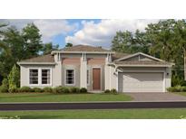 One-story home with a two-car garage, light beige exterior, and landscaping at 4807 Waltham Forest Dr, Davenport, FL 33837