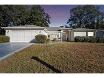 Single-story house with attached garage and well-manicured lawn at 14544 Sw 112Th Cir, Dunnellon, FL 34432