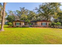 Charming ranch home with a landscaped yard and mature trees at 6104 Irby W Ln, Lakeland, FL 33811