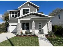 Charming two-story home with a well-manicured lawn, inviting entryway, and a classic architectural design at 1701 Ferris Ave, Orlando, FL 32803