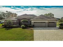 One-story home with a three-car garage and landscaped yard at 958 Lake Deeson Pt, Lakeland, FL 33805