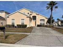 Two-story house with a large yard and attached garage at 108 Emeraldview Ave, Davenport, FL 33897