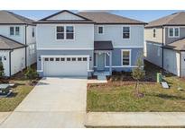 Charming two-story home with a well-manicured lawn and an attached two-car garage at 1622 Ruby Ln, Lake Alfred, FL 33850