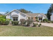 Charming single-story home featuring manicured landscaping and classic architectural details at 515 Torres Pl, Lady Lake, FL 32159
