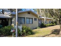 Tan single story house with a spacious yard at 20076 The Granada, Dunnellon, FL 34432