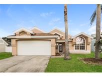 Charming single-Gathering home with a two-car garage and well-maintained lawn at 2504 Davenport Cir, Kissimmee, FL 34746