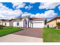 Single-story home with tile roof, paver driveway, and landscaped lawn at 379 Villa Sorrento # Lot 40, Haines City, FL 33844