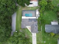 Aerial view showing home with pool and solar panels at 5615 Driftwood Dr, Lakeland, FL 33809