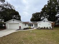 Newly renovated home with a modern exterior and solar panels at 605 Aldama Ct, Ocoee, FL 34761