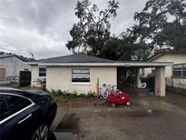 Charming single-story home with a carport, features a tidy front yard and convenient covered parking at 1211 6Th Ne St, Winter Haven, FL 33881