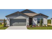 Charming single-story home features a gray exterior, a two-car garage, and a well-manicured lawn at 5329 Sw 81St Cir, Ocala, FL 34481