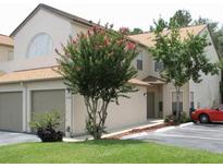Two-story townhome with attached garage and landscaped yard at 2948 W Cottage Grove Ct # Ge, Orlando, FL 32822