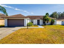 Single-story home with attached garage and well-maintained lawn at 3088 Sire Trl, Lakeland, FL 33811