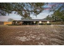 Ranch-style home with a large yard and mature trees at 2028 Marker Rd, Polk City, FL 33868