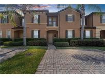 Two-story townhome with brick paver walkway at 225 Cambria Ave, Davenport, FL 33897