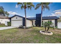 Updated home exterior boasts a modern design, fresh landscaping, and a two-car garage at 5727 La Serena Ave, Lakeland, FL 33809