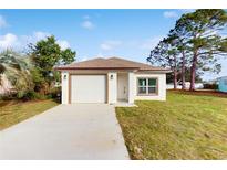 Newly constructed single story home with attached garage and well-manicured lawn at 223 Stanley Ave, Frostproof, FL 33843