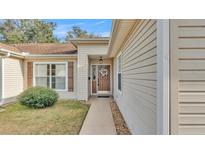 Inviting home exterior with a wreath on the front door and neutral siding at 4064 River Crest Cir, Leesburg, FL 34748