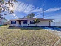 Brick ranch home with white picket fence and spacious yard at 6205 Indian Ln, Lakeland, FL 33813