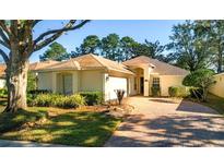 One-story house with a brick driveway and landscaped front yard at 7006 Arcadian Ct, Mount Dora, FL 32757