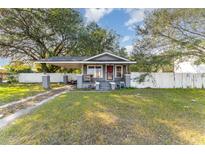 Gray house with carport, fenced yard, and landscaping at 820 Lakeshore Dr, Lakeland, FL 33801