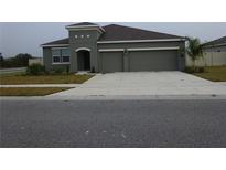 Charming single-story home with a two-car garage and well-maintained landscaping at 400 Watusi Way, St Cloud, FL 34772