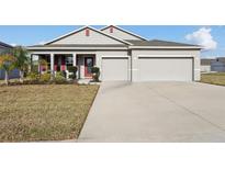 Charming single-story home featuring a well-manicured lawn and a two-car garage at 930 Fieldstone Way, Haines City, FL 33844
