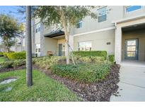 Inviting townhome with a well-manicured lawn and covered entryway at 760 Pebble Beach Dr, Davenport, FL 33896