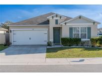 Charming single-story home featuring a two-car garage, well-kept lawn, and a freshly painted exterior at 637 Bernard Ln, Davenport, FL 33837