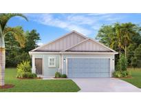 New construction home with light blue exterior, two car garage, and palm trees at 5806 Le Marin Way, Kissimmee, FL 34758