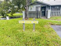 Charming condo exterior with well-maintained lawn and a view of the community pond at 200 Lemon Tree Ln # A, Ormond Beach, FL 32174