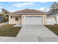 Charming single-story home featuring a large two-car garage and well-maintained lawn at 835 Texas Ave, Lakeland, FL 33815