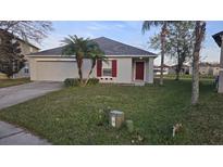 Charming one story home with landscaped yard and attached two car garage at 1907 Eliza Ann St, Kissimmee, FL 34758