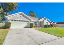 Charming single Gathering home featuring a two car garage and well-maintained landscaping at 6830 Krenson Oaks Cir, Lakeland, FL 33810