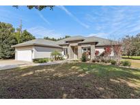 Charming single-story home with stone accents and a well-manicured lawn at 562 Dowling Cir, Lady Lake, FL 32159