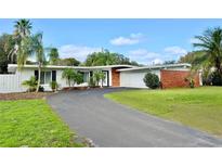 Charming single-story home featuring a well-manicured lawn, attached garage and a long driveway with beautiful curb appeal at 1231 Sidcup Rd, Maitland, FL 32751