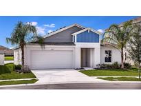 Inviting exterior of a two-story home with a well-manicured lawn and attached two car garage at 1604 Ellesmere Ave, Haines City, FL 33844