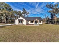 Charming single-story home with a well-manicured lawn and stone accents at 7 Hill Prince Dr, Ocala, FL 34482