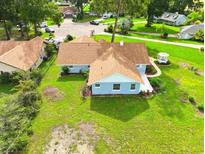 Charming single story home on a large lot featuring a manicured lawn and a quaint gazebo at 10672 Sw 75Th Ter, Ocala, FL 34476