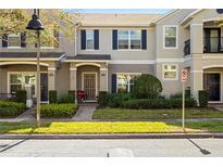 Charming townhome featuring blue shutters, a well-manicured lawn and a welcoming front entrance at 12313 Citruswood Dr, Orlando, FL 32832