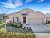 Charming single-story home featuring a well-maintained lawn and inviting front entrance and attached two car garage at 3214 Bayou Bay Dr, Lakeland, FL 33811