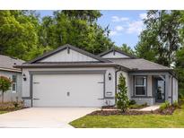 Charming single-story home with a two-car garage and beautifully landscaped front yard at 5421 Sw 82Nd Ter, Ocala, FL 34481
