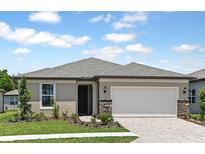 Charming one-story home with neutral stucco, stone accents, well-maintained landscaping, and a two-car garage at 9009 Sw 52Nd Place Rd, Ocala, FL 34481