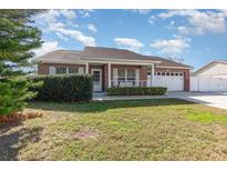 Charming single-story brick home with a well-manicured front yard and attached two car garage at 8465 Split Creek Cir, Lakeland, FL 33809