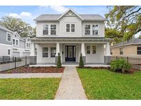 Charming two-story home with inviting front porch, manicured lawn, and well-maintained landscaping at 2308 Depauw Ave, Orlando, FL 32804