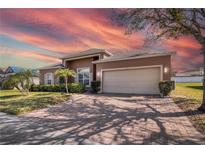 Charming single Gathering home with two car garage and mature landscaping at 3890 Wood Thrush Dr, Kissimmee, FL 34744