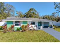 Charming single-story home with a lush green lawn and beautifully landscaped front yard at 1730 John Arthur Way, Lakeland, FL 33803