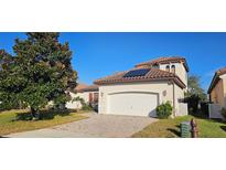 Charming single Gathering home with a two car garage, tile roof and solar panels on the roof at 315 Villa Sorrento Cir, Haines City, FL 33844