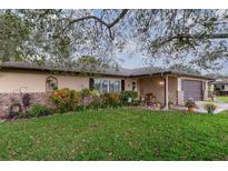 Charming home showcasing a well-manicured lawn and meticulously maintained landscaping at 1176 Balfour Dr, Deltona, FL 32725