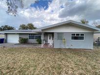 Charming single-story home with gray exterior, well-kept lawn, and inviting front porch at 753 Avenue O Se, Winter Haven, FL 33880